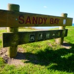 Like RSA, NZ has a "Sandy Bay". Unlike RSA, it is not a nudist beach.